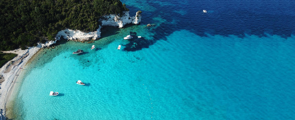 Aerial drone ultra wide photo of paradise tropical exotic white rocky deep turquoise seascape forming a blue lagoon in Caribbean popular destination © aerial-drone