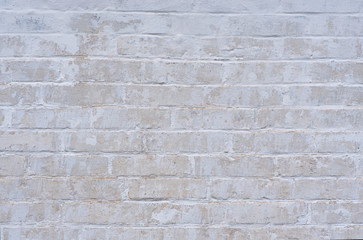 White weathered wall, peeling wall, made of silicate brick. Texture.