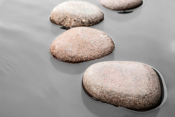 Fototapeta na wymiar Wet stones in water, closeup. Zen lifestyle