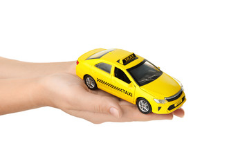 Woman with taxi car model on white background, closeup