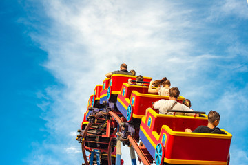 Roller coaster in an amusement park, extreme relaxation for adults and children. - obrazy, fototapety, plakaty