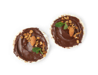 Puffed rice cakes with chocolate spread, nuts and mint isolated on white, top view