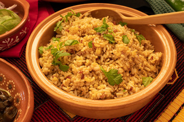 Mexican rice and quinoa in clay dish