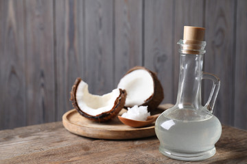 Coconut oil on wooden table. Space for text