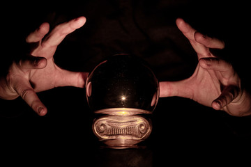 Hands over crystal ball in dark room, crystal ball gazing, crystal ball psychic, crystal ball fortune telling, crystal ball scrying, crystal ball object of power, seance with crystal ball 8