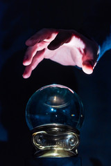 Hand over crystal ball in dark room, crystal ball gazing, crystal ball psychic, crystal ball fortune telling, crystal ball scrying, crystal ball object of power, seance with crystal ball 3