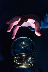 Hand over crystal ball in dark room, crystal ball gazing, crystal ball psychic, crystal ball fortune telling, crystal ball scrying, crystal ball object of power, seance with crystal ball 2