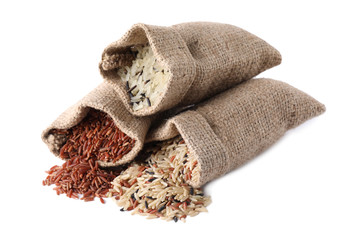 Brown and polished rice in bags isolated on white