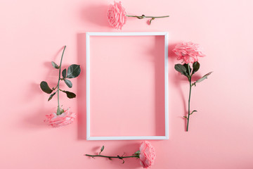 Beautiful flowers composition. Blank frame for text, pink rose flowers on pastel pink background....