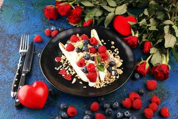 Sweet Homemade Banana Split with yogurt, granola, berries and mint. Banana Split with healthy ingredients