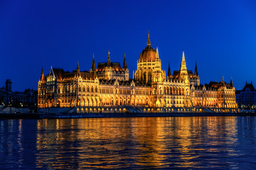 Hungarian Parliament Building (Orsaghaz) at night with illumination on the Danube River, Hungary.