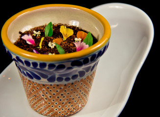 Fine dining chocolate cheesecake and edible flowers