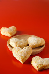 Heart shaped sugar cookies on red background