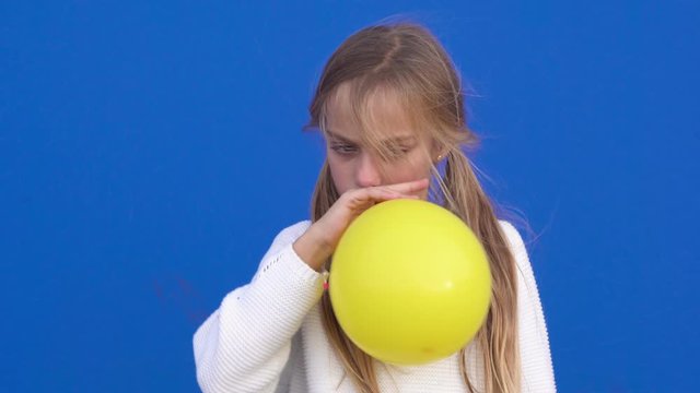 Joyful girl with yellow balloon