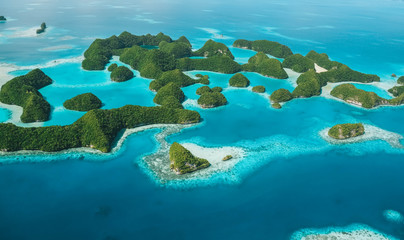 Birds eye view shot of scattered islands covered in greenery