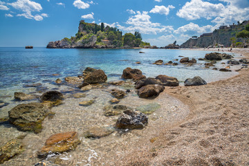 Fototapeta na wymiar Taormina - The beautifull little island Isola Bella and the beach with the pumice stones.