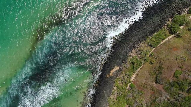 Waves hitting shoreline in Burleigh Heads, Gold Coast. Aerial overhead