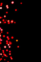 Fototapeta na wymiar Black background with bright red warm bokeh lights. Holiday, Valentines, Christmas and New Year background. Ideal to layer with any design. Horizontal