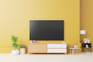 Cabinet tv and yellow wall in living room.