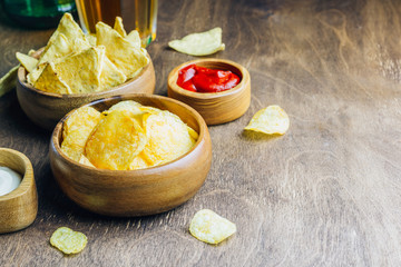 Table fof tasty snacks and beer prepared for watching sports on TV. Selective focus