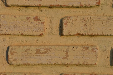 The brown-brown brick wall has a rectangular hole.
