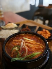 Korean Kimchi Soup on table with other ingredients