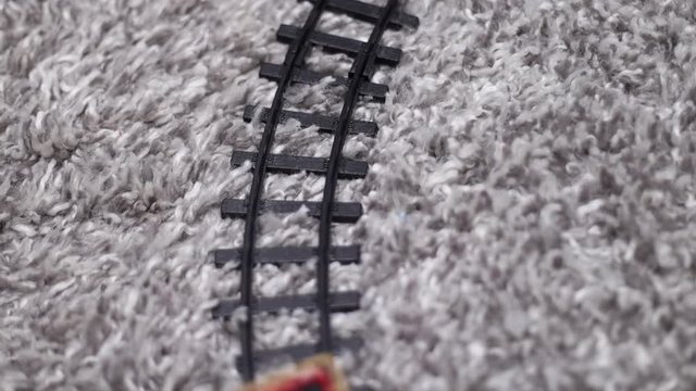 plastic toy train running on tacks