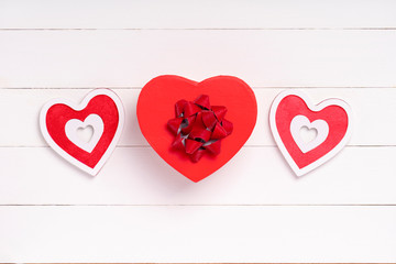 Valentines Day composition. Heart, gift on white wooden surface. Valentine's day concept. Flat lay, top view, from above