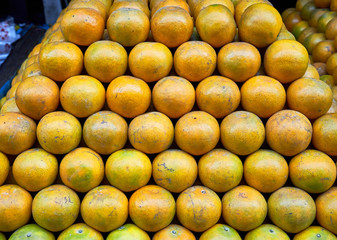 Fresh oranges built up in form of a pyramid at a market in Bangkok, Thailand