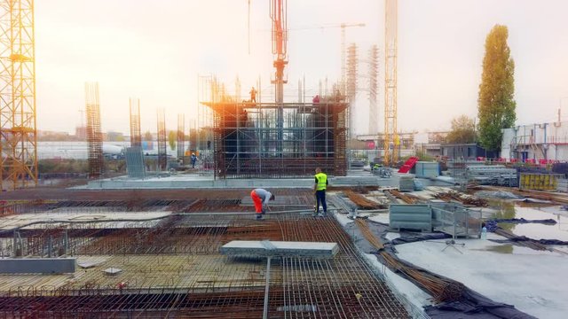 Busy construction site with workers and cranes