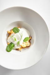 Baked Cauliflower with Cream Sauce and Fresh Greens Isolated