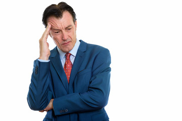 Studio shot of mature stressed businessman having headache