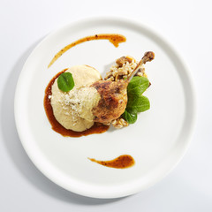 Duck Leg Confit with Pearl Barley on Restaurant Plate Isolated