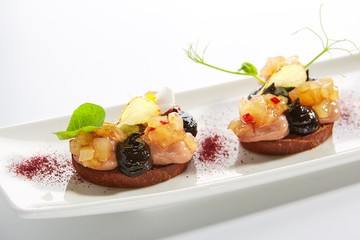 Duck Pate on Toasted Bread with Truffle Oil and Prune Cream Isolated