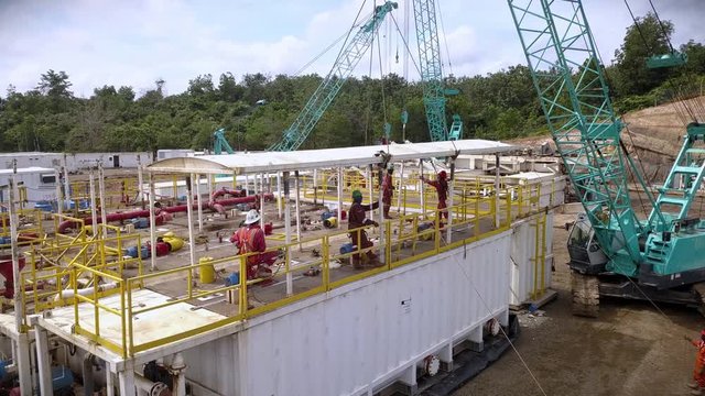 Aerial shot of onshore oil rig mud tank roof installation.