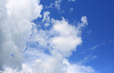 Blue sky and fluffy clouds background.