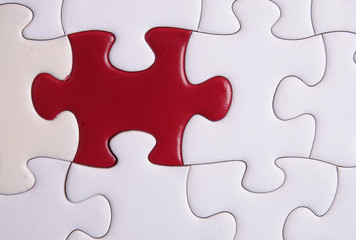 Fototapeta premium Red puzzle on white background. Copy space