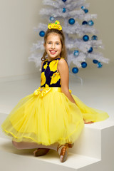 The girl at the Christmas tree.Beautiful little girl near the Ch