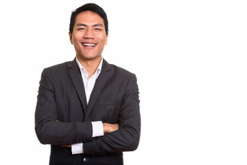Studio shot of young Asian businessman with arms crossed