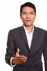 Close up of young Asian businessman giving handshake