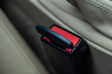 Obraz premium A plastic plug inserted in the connector for the car seat belt to reject the sensor signal. Violation of safety rules and road traffic. Unjustified risk.