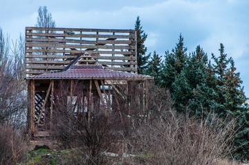 An unfinished business project grows. Abandoned unfinished wooden frame of a residential building on the seashore. Illegal development.