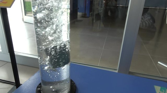 Mentese, Mugla, Turkey - 15th of November 2019: 4K At the Mentese scientific park - Floating object sinks in bubbling water Experiment