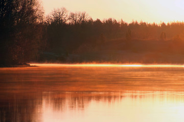 Fog over a shiny lake