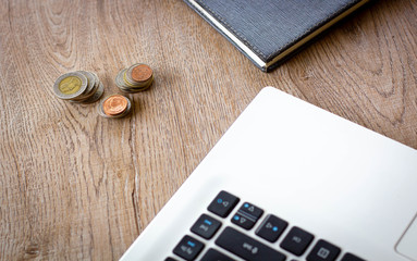 Laptop computer on wood table top view with copy space. Office supplies and gadgets on desk table.