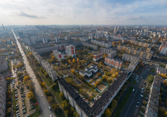 Fototapeta na wymiar Aerial view of Ekaterinburg city. District of the city - Elmash. Autumn, sunny. Yellow leaves on trees