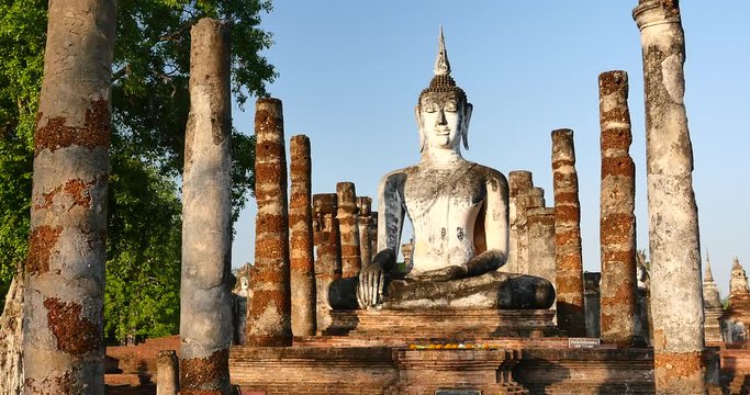 4k Mahathat temple in Sukhothai historical park; Thailand.Seated Buddha(Phra Atchana) at Wat Si Chum temple in Sukhothai Historical Park; a UNESCO world heritage site; Thailand. 