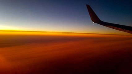airplane flying above clouds