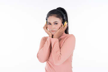 Cheerful Asian teenager wearing turtleneck and pants using wireless headphones enjoying listening to music isolated on white background. Easy to cut out. Landscape orientation.