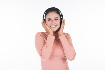 Cheerful Asian teenager wearing turtleneck and pants using wireless headphones enjoying listening to music isolated on white background. Easy to cut out. Landscape orientation.